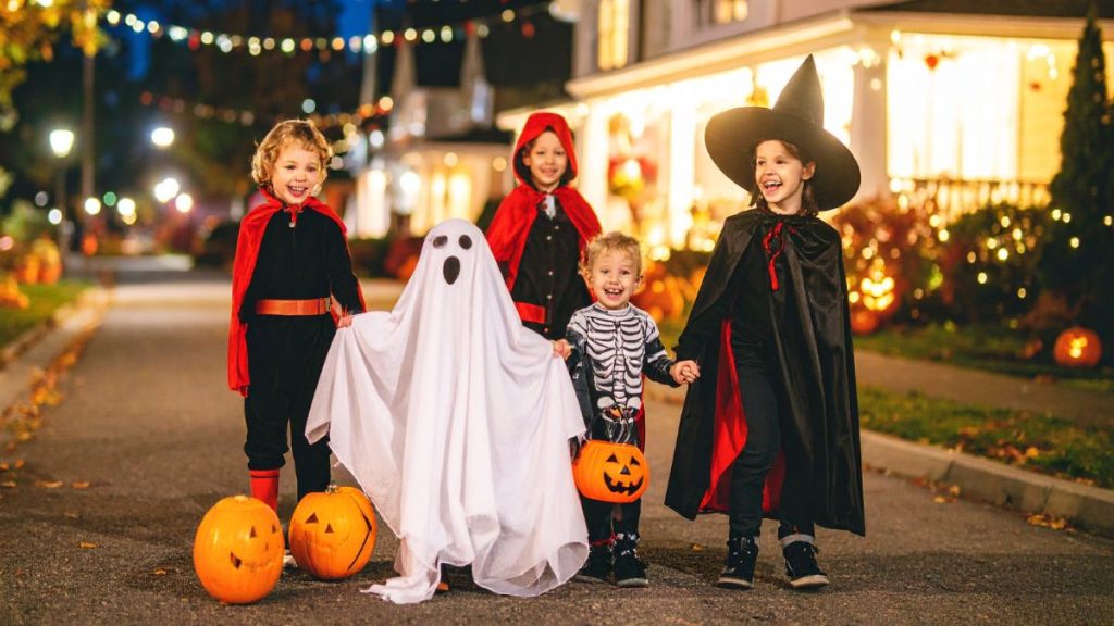 Halloween Trick or Treaters in Costume on a Lit Street
