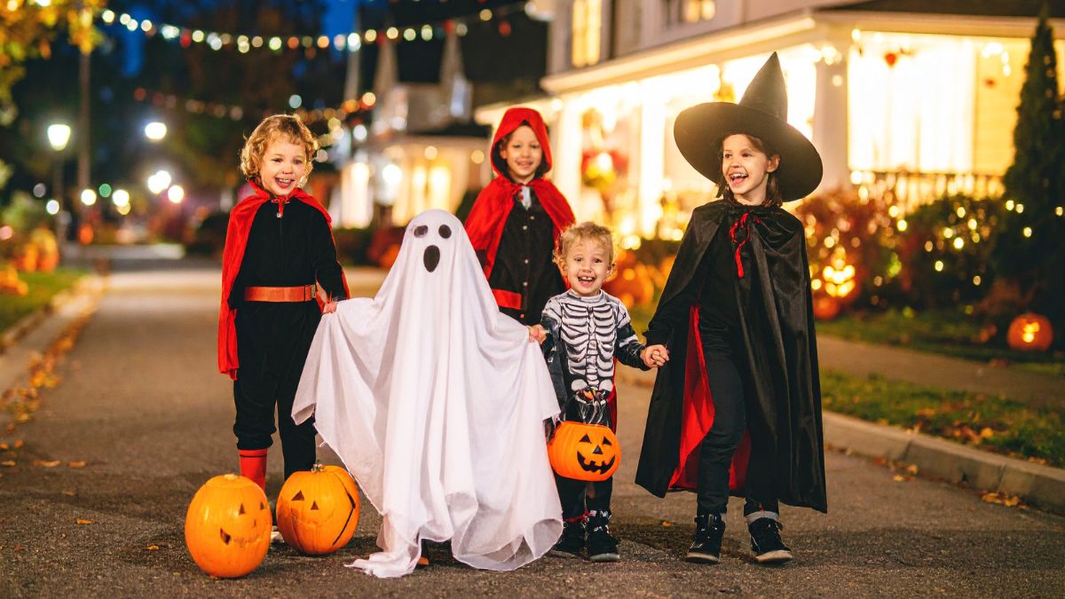 Halloween Trick or Treaters in Costume on a Lit Street