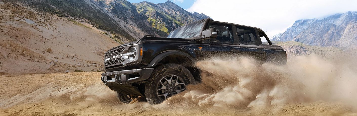 Black 2026 Ford Bronco Kicking Up Sand in a Desert
