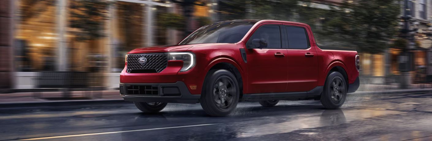 Red 2026 Ford Maverick Driving on Rainy City Street