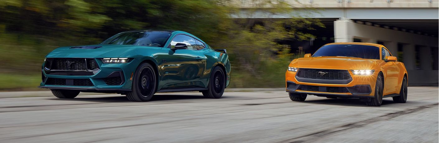Green and Orange 2026 Ford Mustang Models on a City Street
