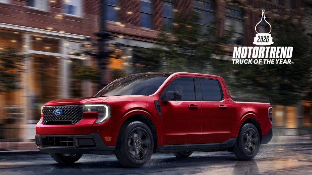 Red 2026 Ford Maverick on City Street with MotorTrend Truck of the Year Graphic