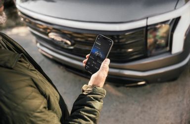 Man Using Ford Mobile App by Ford F-150 Lightning