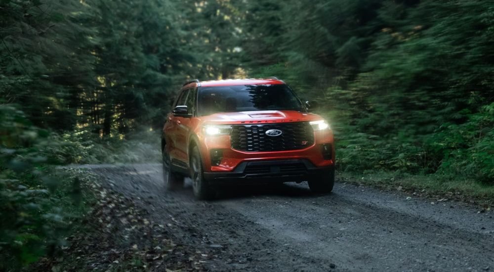 Red 2025 Ford Explorer ST driving on a trail