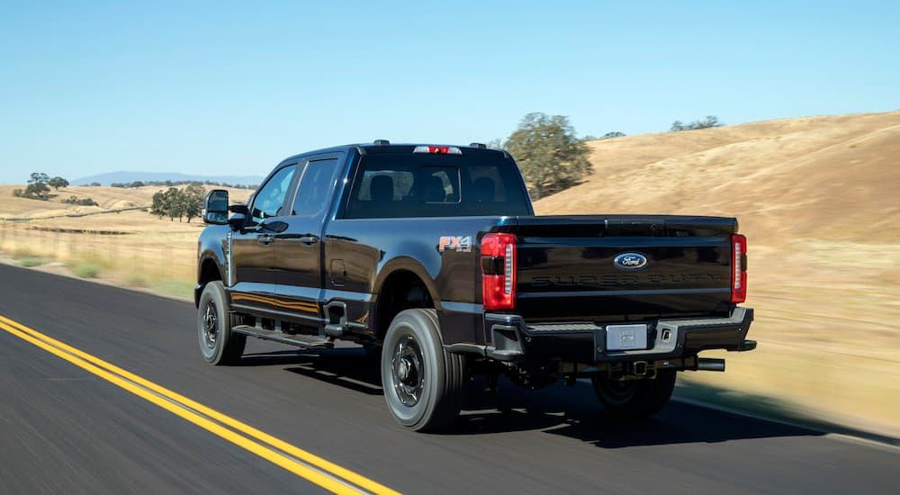 A black 2025 Ford F-150 from the rear at an angle.