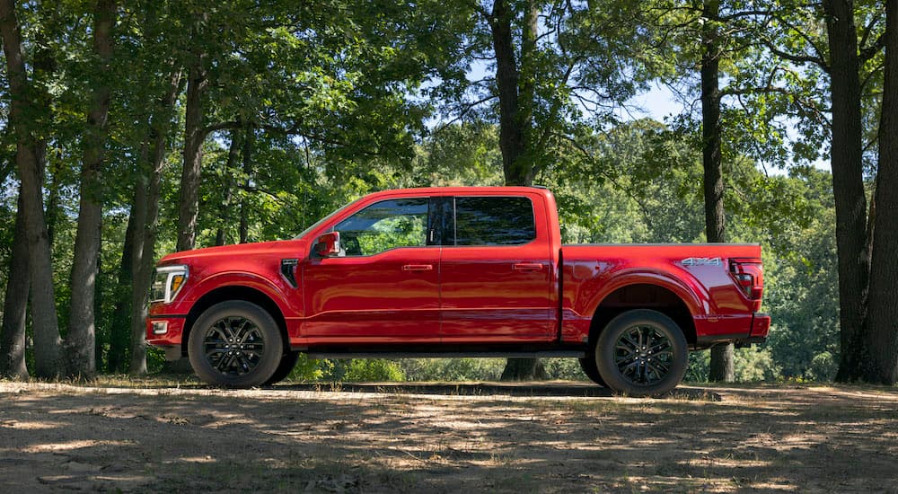 A red 2025 Ford F-150 from the side.