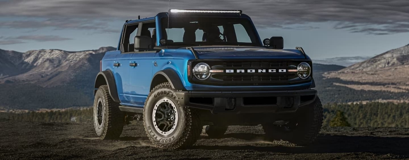 A blue 2022 Ford Bronco parked off-road.