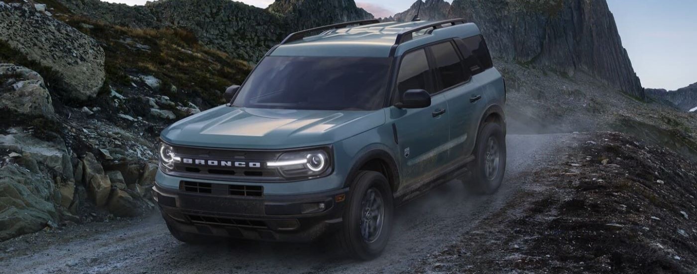 A blue 2025 Ford Bronco Sport off-roading on a dirt trail