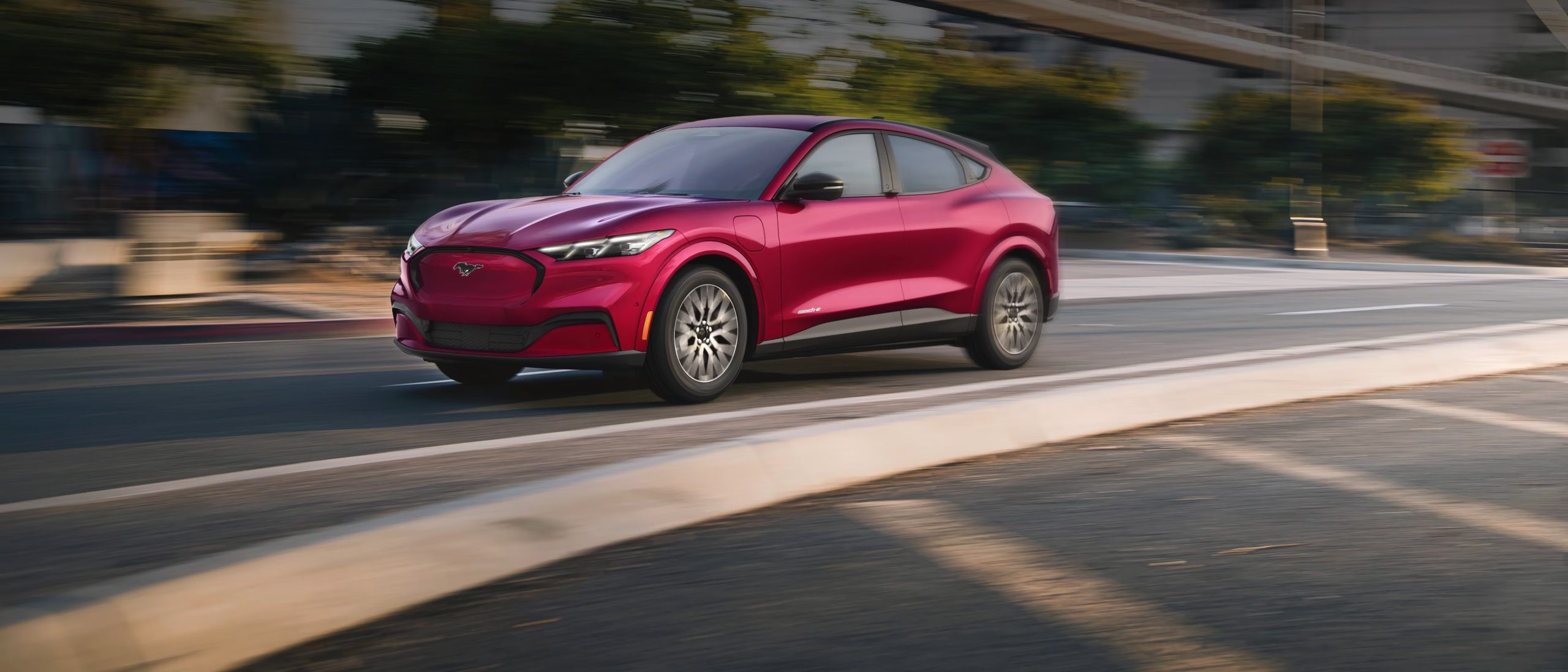 2025 Ford Mustang Mach-E driving around a curve 2025 Ford Mustang Mach-E driving around a curve