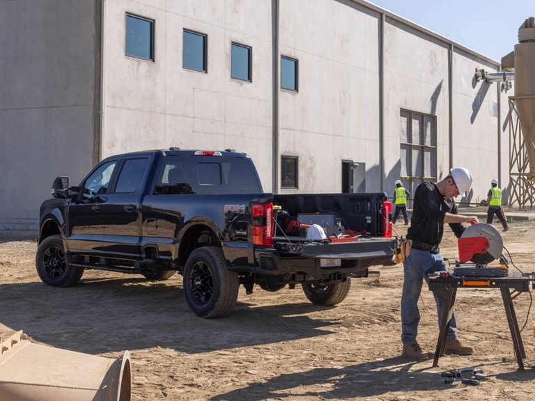 A black Ford Super Duty at a construction site
