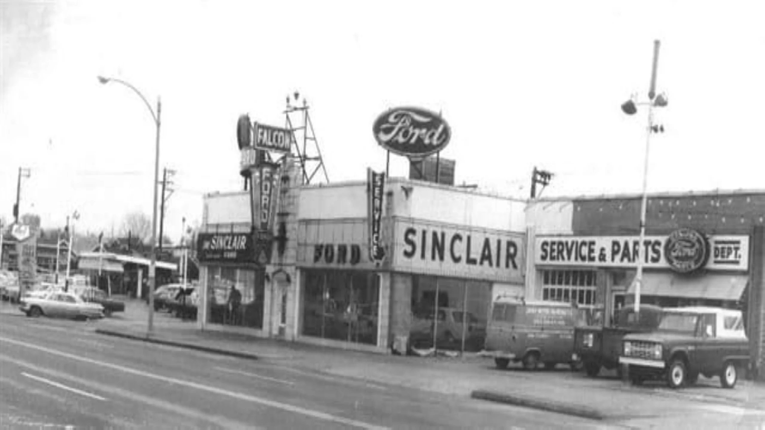 The original Dave Sinclair Ford dealership in its early years, with the Ford oval sign, the Sinclair showroom and the service and parts department