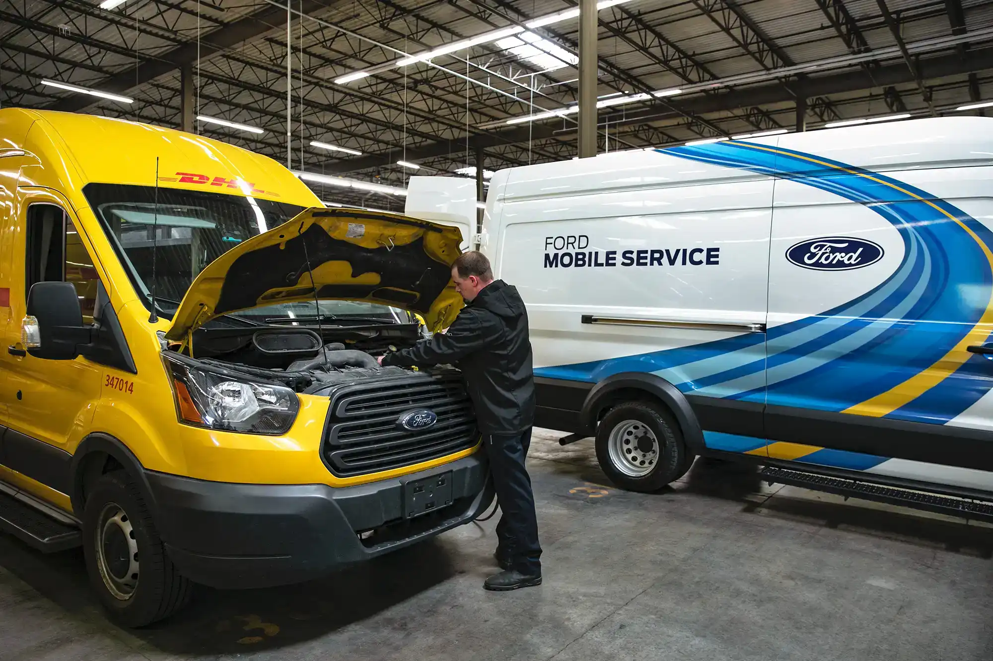 Ford Mobile Service Technician Looking under the hood of a Transit Van