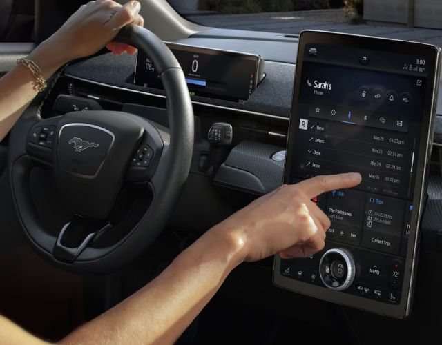 Friendly Ford Driver Interacting With Ford SYNC 4 System