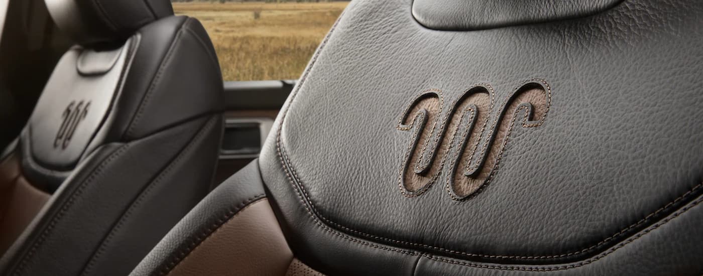 A close up shows the King Ranch badge on the leather seat of a 2022 Ford Explorer King Ranch.