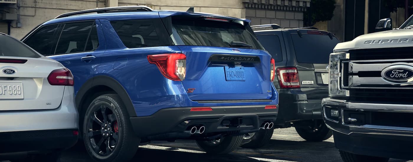 A blue 2022 Ford Explorer ST is shown reversing near a Ford Super Duty.