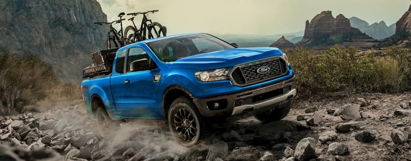 Blue 2023 Ford Ranger XLT driving off-road