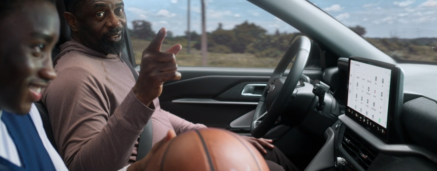 A person holding a basketball in a 2025 Ford Explorer Active.
