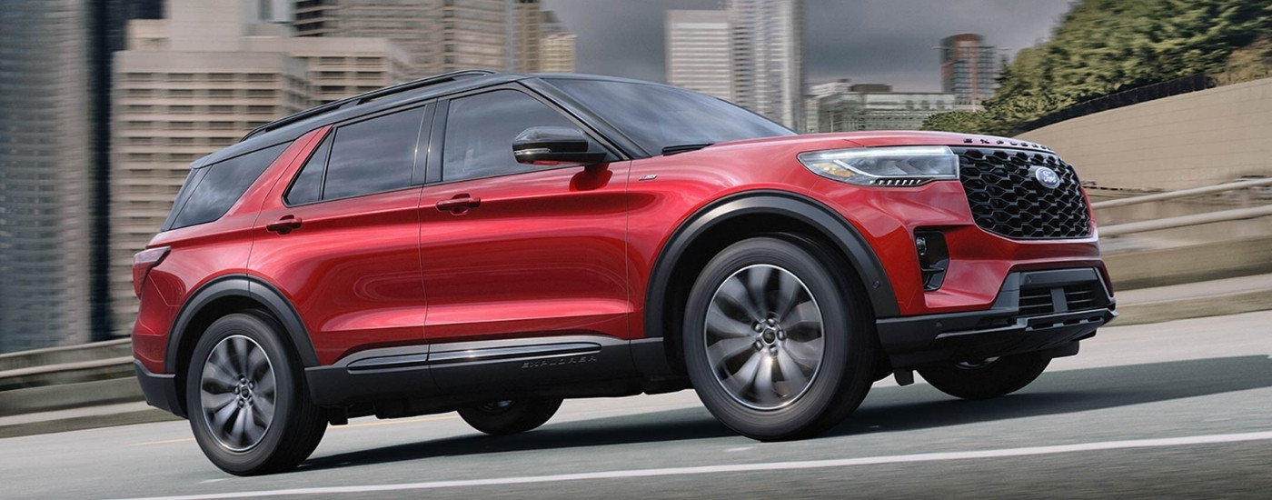 A red 2025 Ford Explorer ST Line driving on a highway