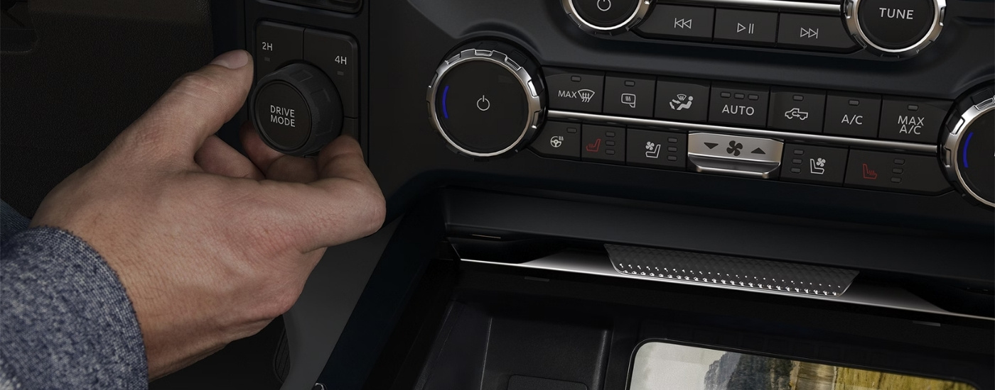 Person turning a drive mode knob in a 2026 Ford F-250