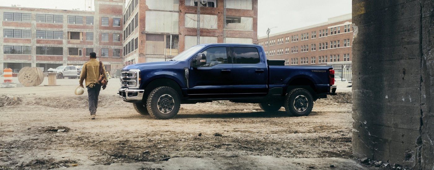 Blue 2026 Ford F-250 Lariat Tremor parked at a construction site