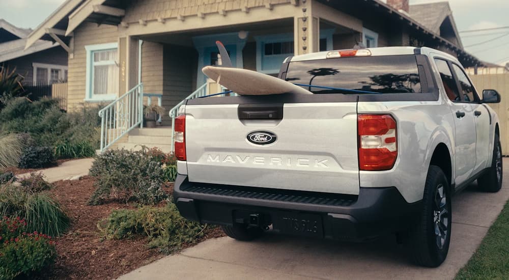 Surfboard in the bed of a white 2026 Ford Maverick
