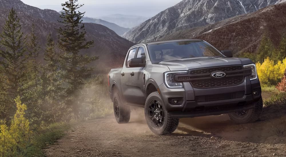 Grey 2026 Ford Ranger driving on a dusty dirt road
