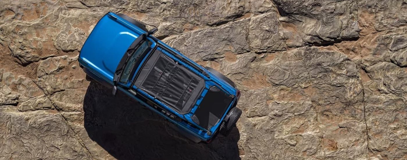 Blue 2023 Ford Bronco parked on a rocky plateau.