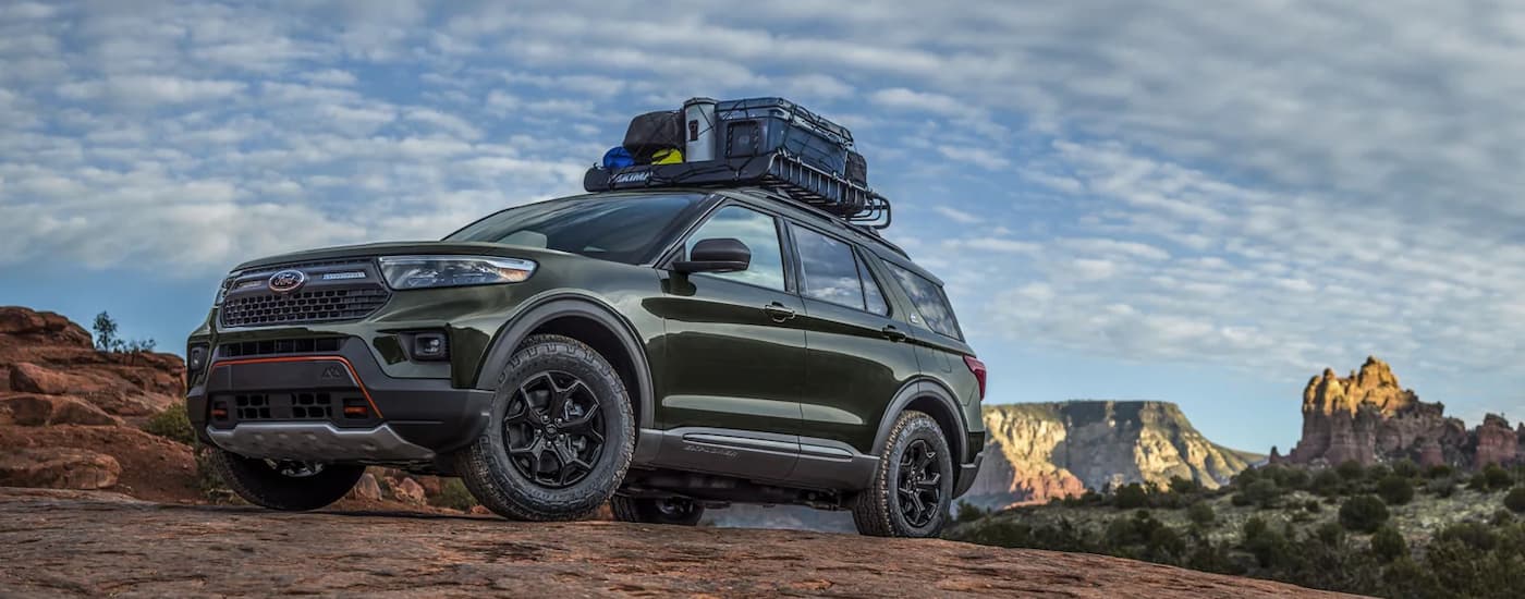 A green 2022 Ford Explorer Timberline is shown on a cloudy day. 