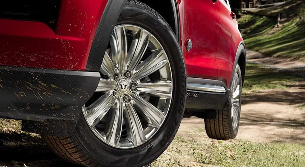 A close up of the front rim on a red 2023 Ford Explorer King Ranch is shown.