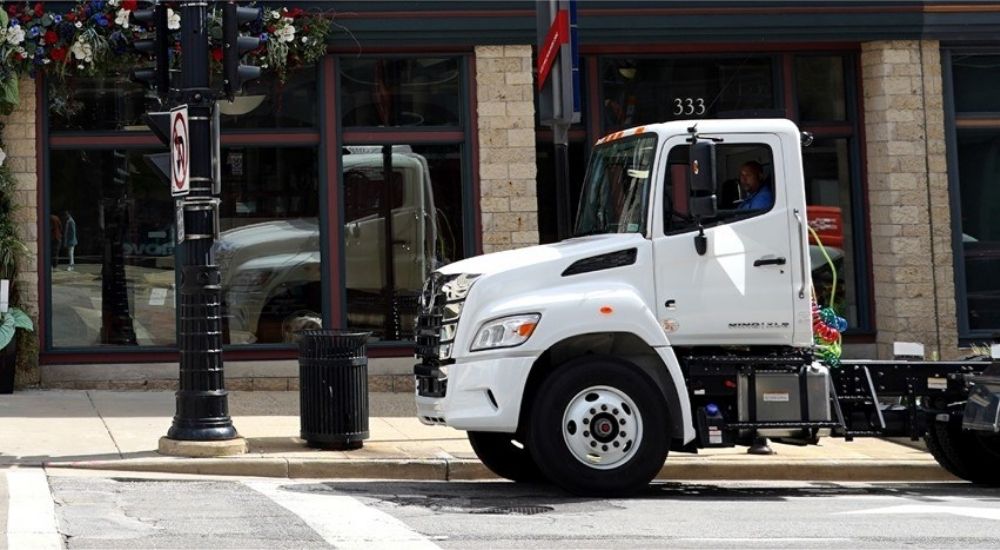 Front side of a white 2025 Hino XL truck.