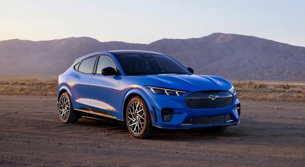Blue 2024 Ford Mustang Mach-E overlooking mountains
