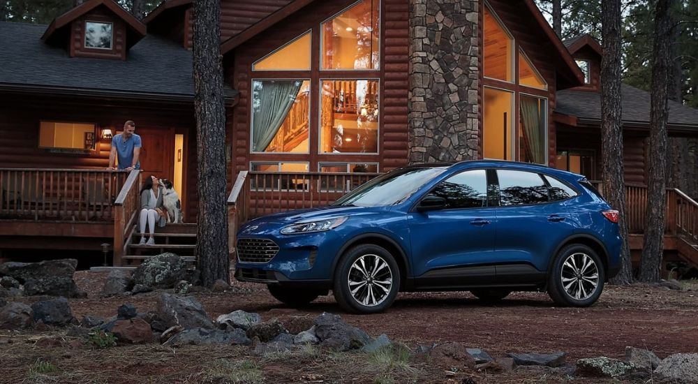 Blue 2020 Ford Escape parked outside of a cabin