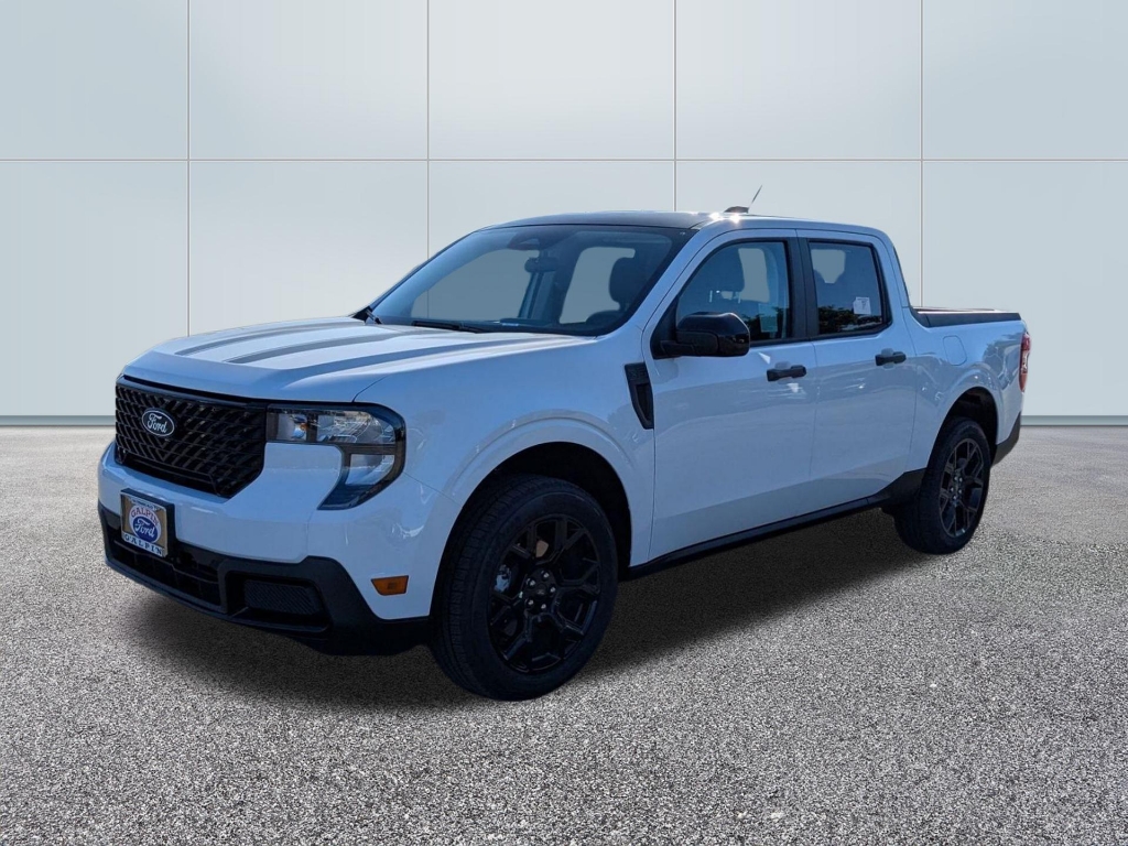 A white 2025 Ford Maverick XLT pickup truck parked on a dealership lot. The vehicle features a crew cab configuration, black grille accents, and dark alloy wheels.