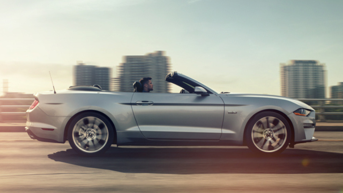 man driving mustang top down