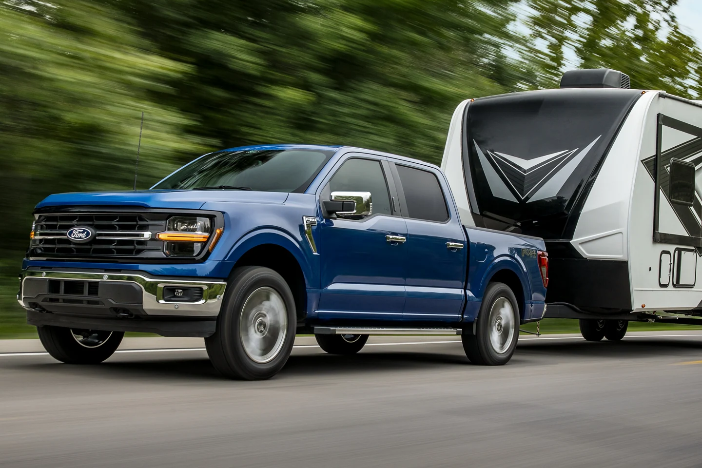 blue Ford F150 Towing Trailer