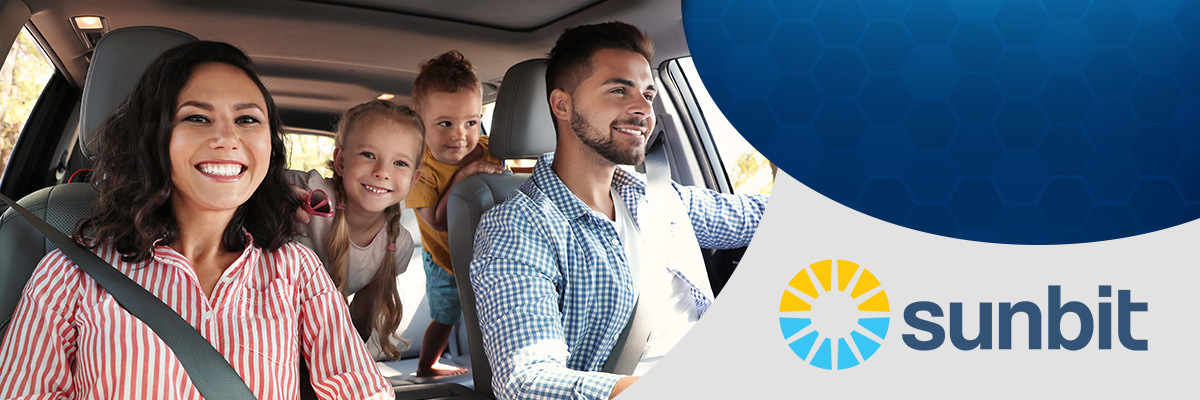 Happy family in a car smiling with Sunbit logo