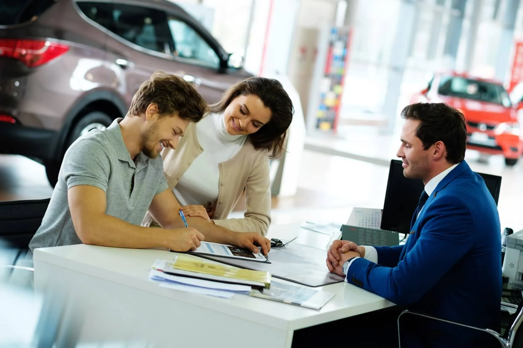 Friendly finance team working with a customer at Leif Johnson Ford