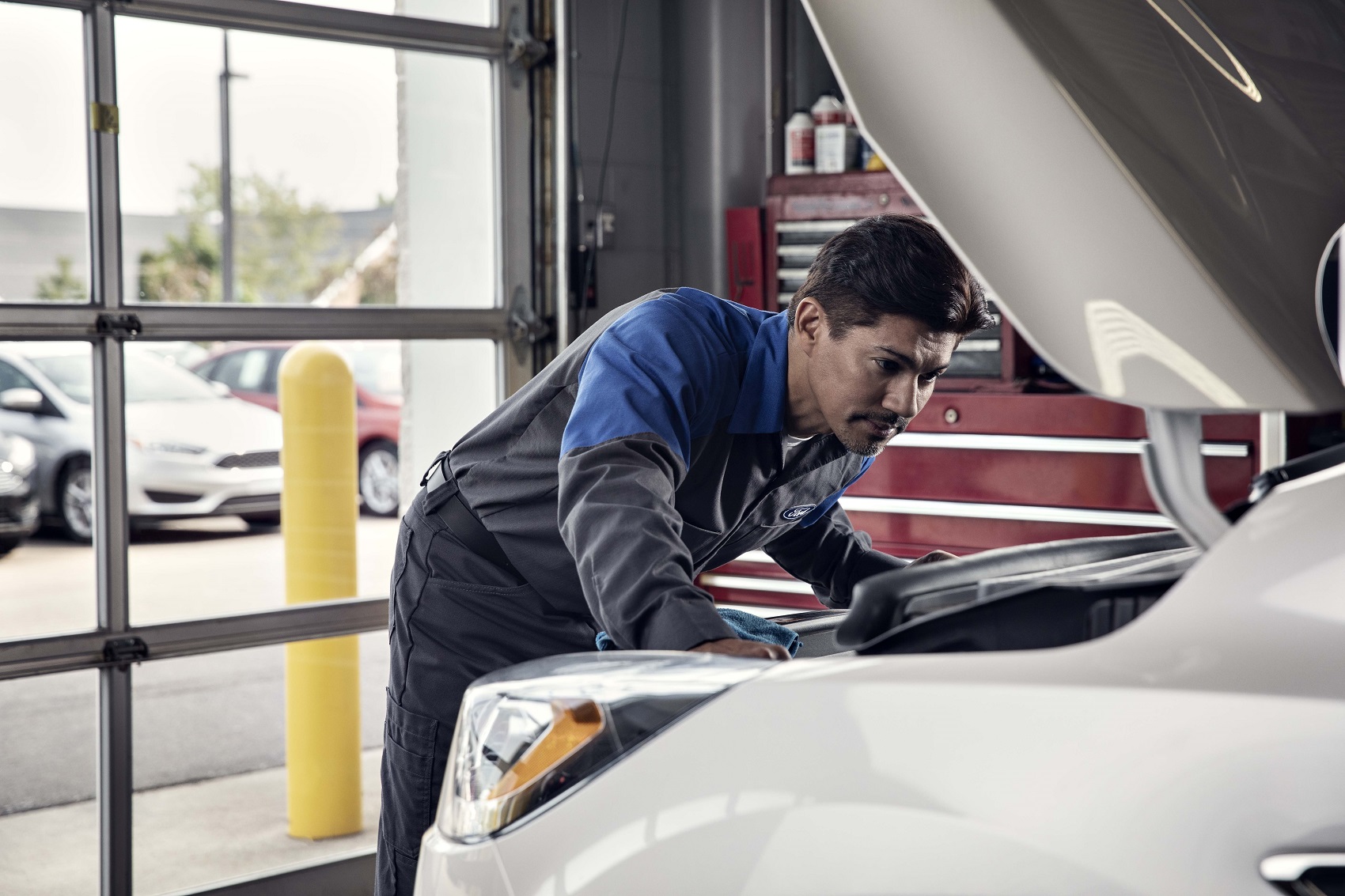 Service technician working on Ford vehicle